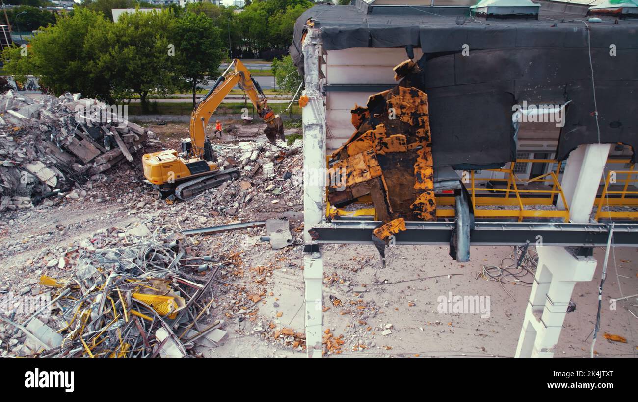 06.08.2022 - Warsaw, Poland - The excavator working on the dismantling and demolition site. High quality photo Stock Photo