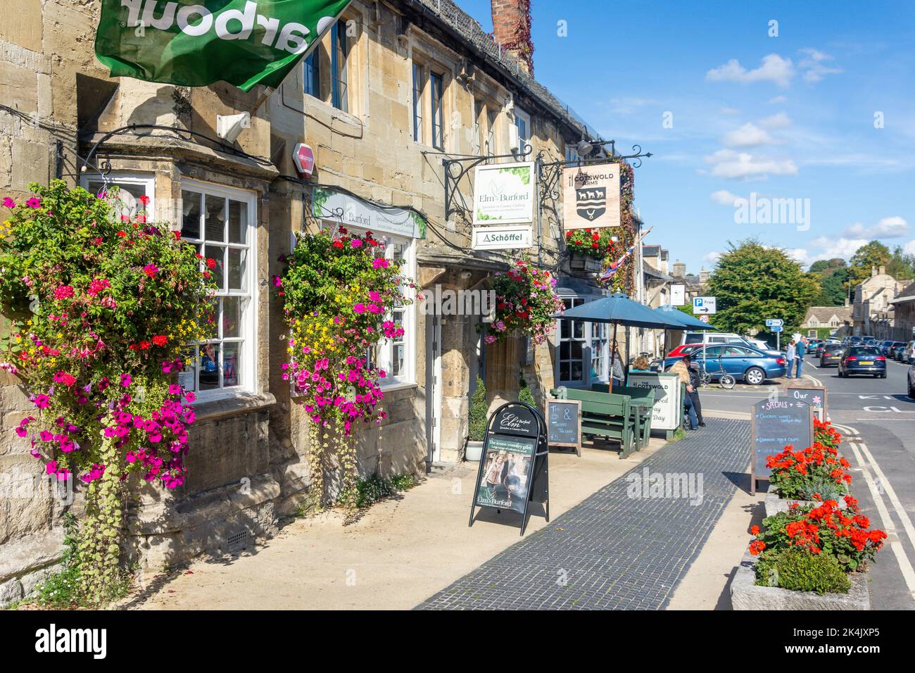 Elm of Burford clothing store and Cotswold Arms, High Street, Burford, Oxfordshire, England, United Kingdom Stock Photo