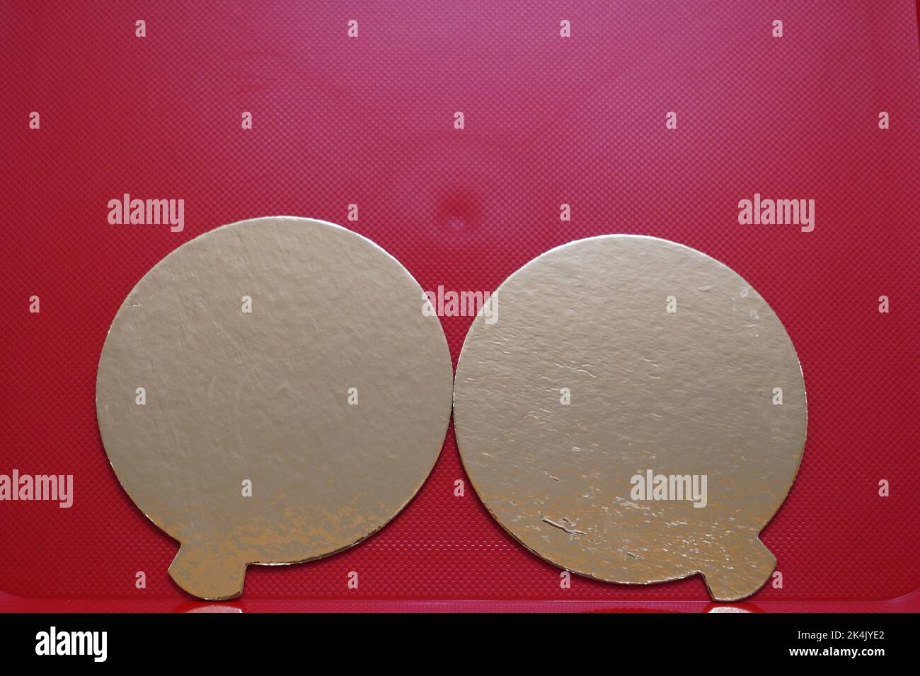 Two golden speech bubbles on a textured red background. Stock Photo