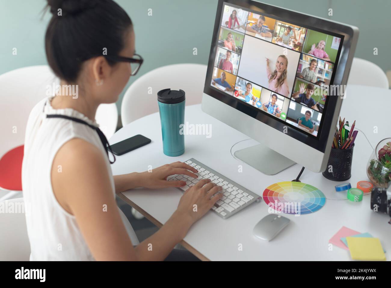 Asian girl using laptop for video call, with smiling diverse elementary ...
