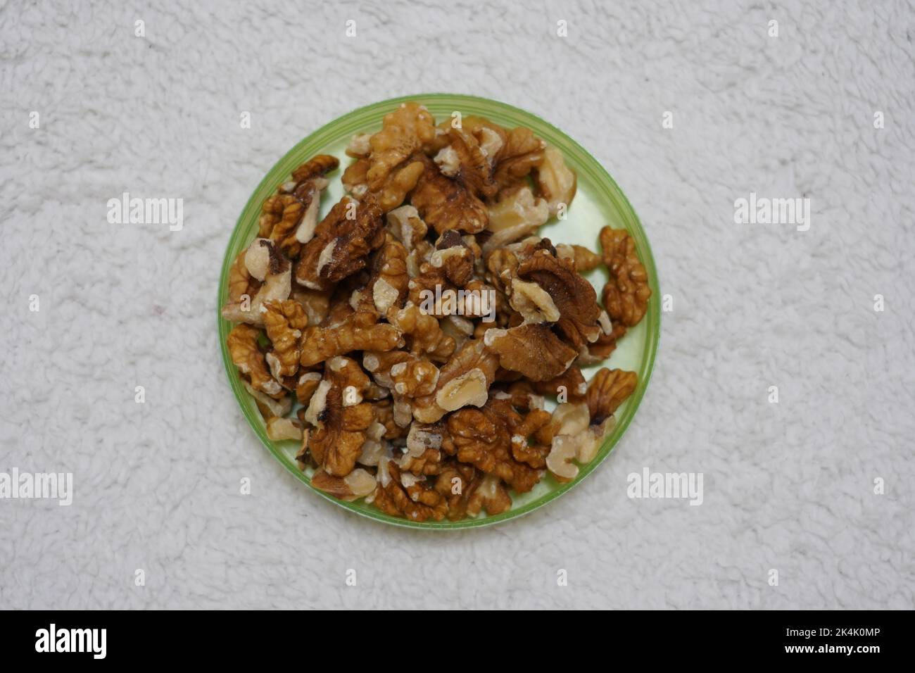 black prunes in glass jar on textured white background Stock Photo Alamy