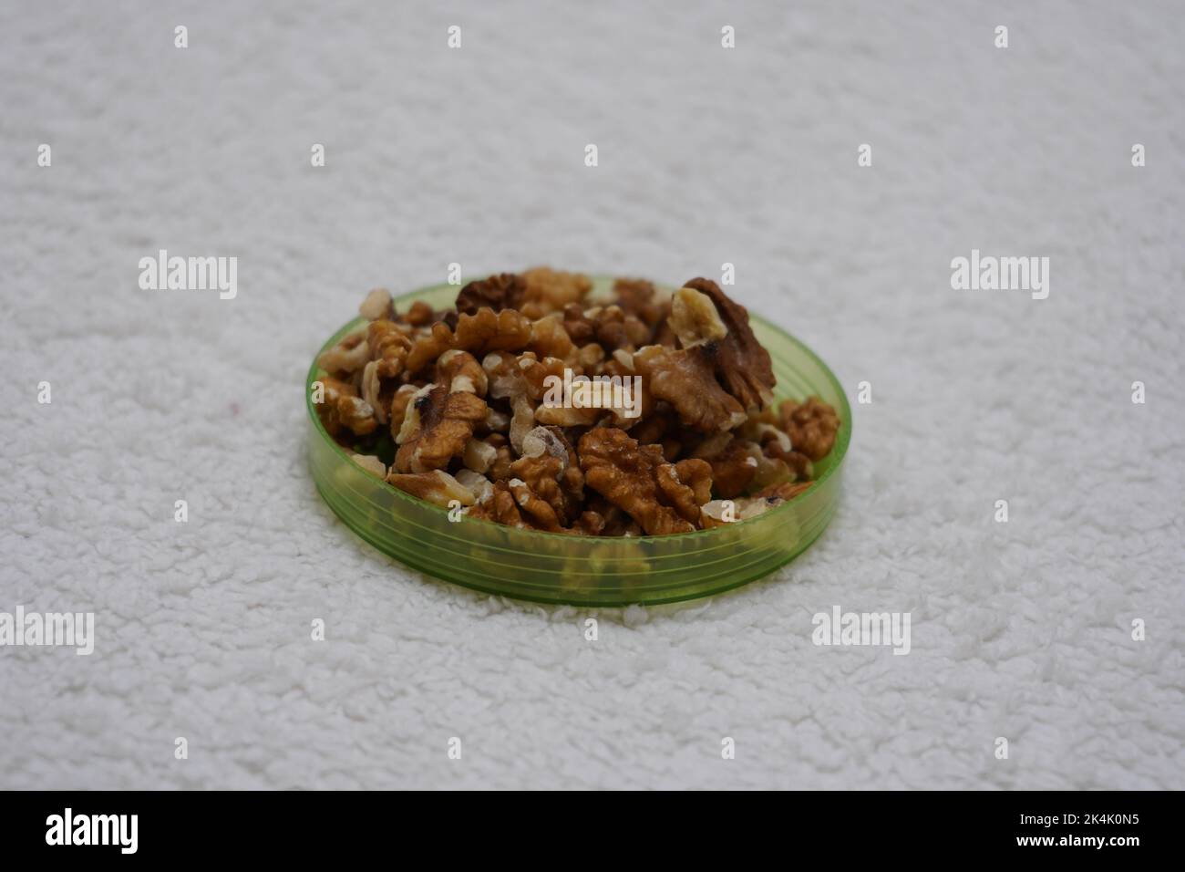 black prunes in glass jar on textured white background Stock Photo Alamy