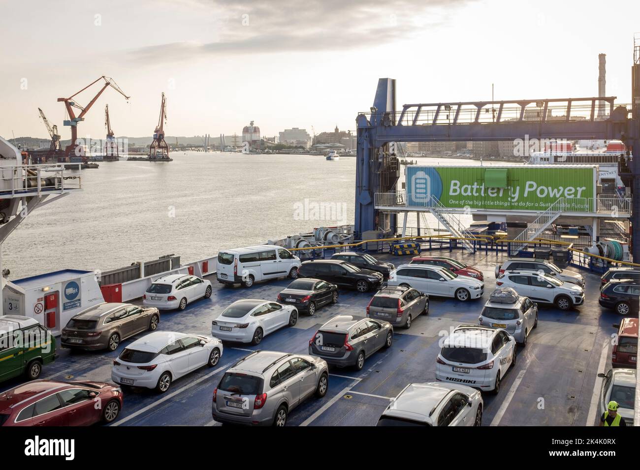 Cars parked on the car deck of the Stena Jutlandica ferry at the ferry terminal of Gothenburg, Sweden. A large sign indicating that the ferry is partly battery powered is seen at the stern of the vessel. Stock Photo