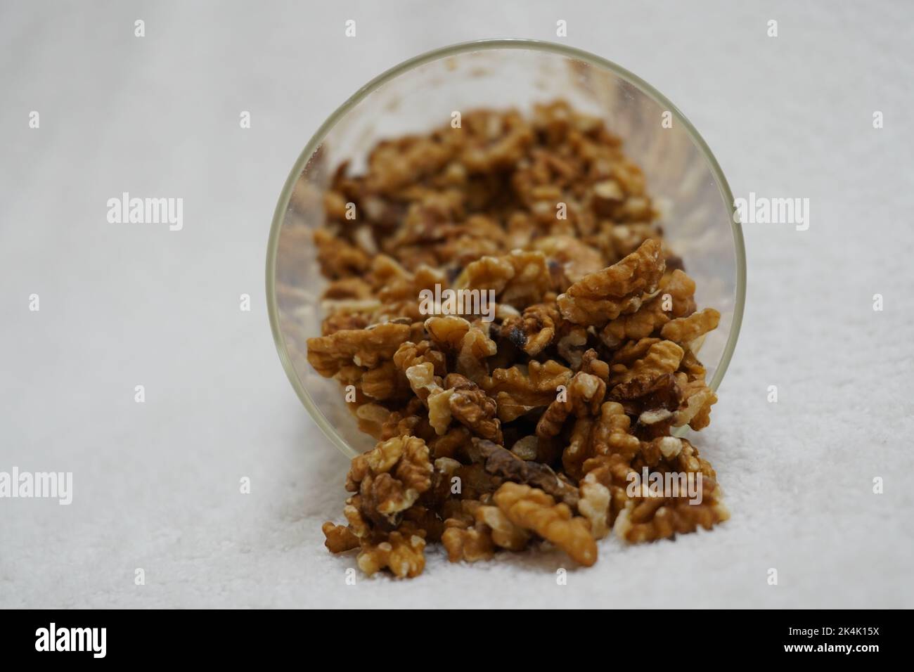 black prunes in glass jar on textured white background Stock Photo Alamy