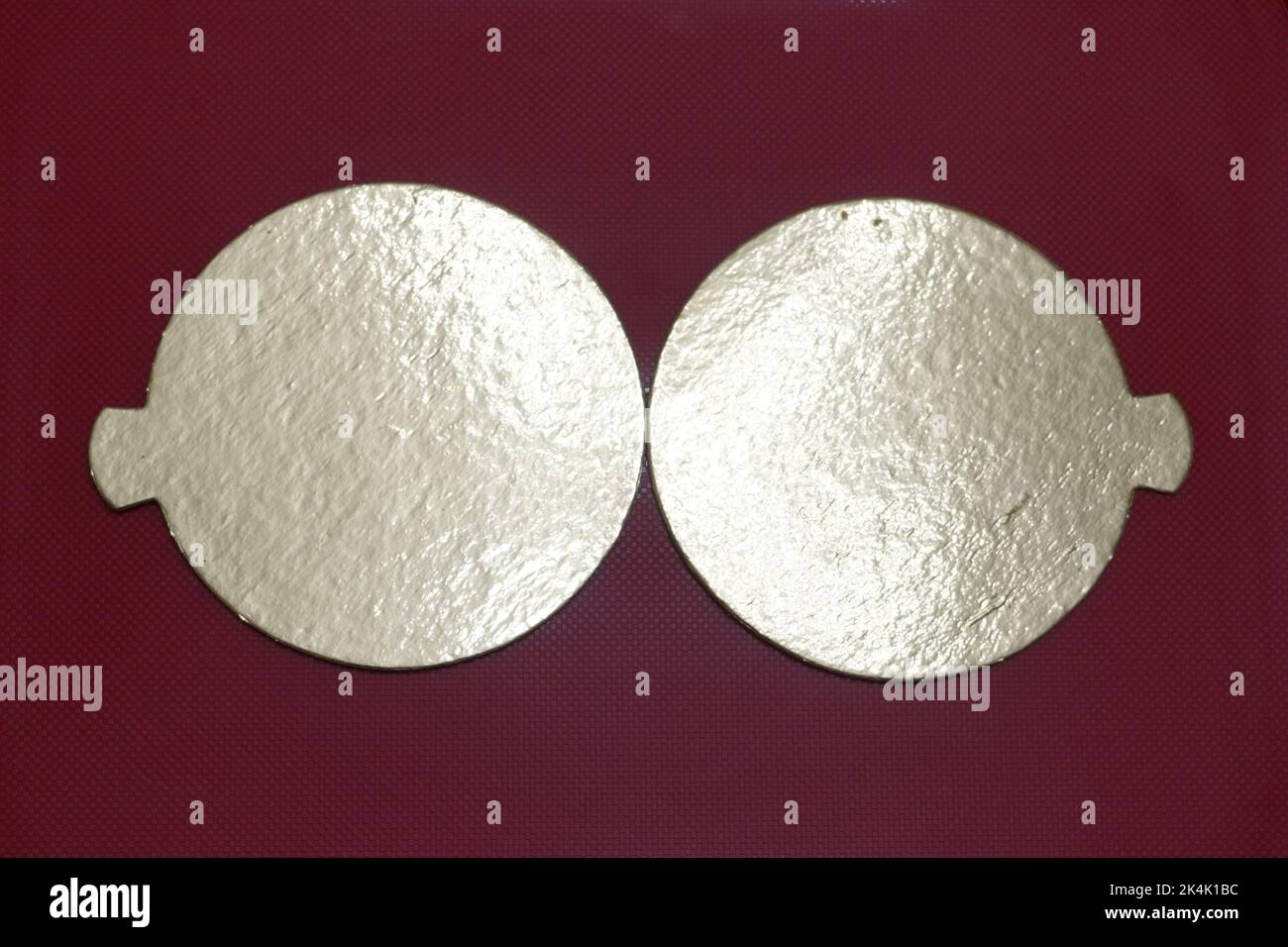 Two golden speech bubbles on a textured red background. Stock Photo