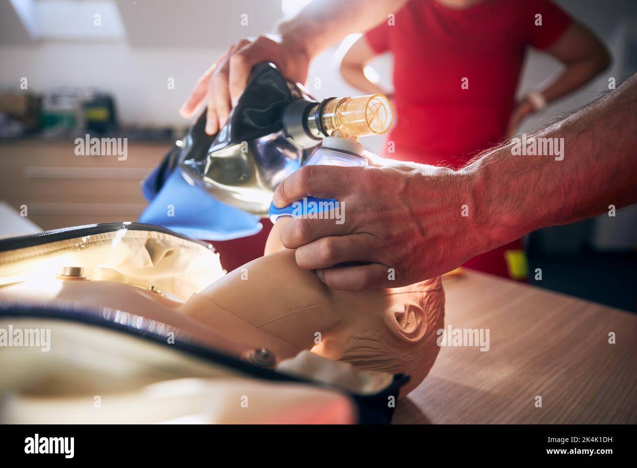 Paramedic of emergency medical service training resuscitation procedure on child dummy. Stock Photo