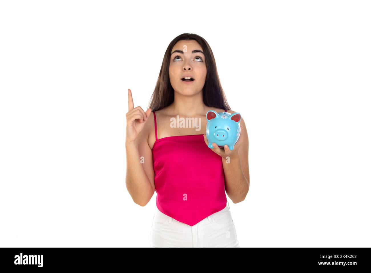 Brunette young girl holding money box isolated on a white background ...