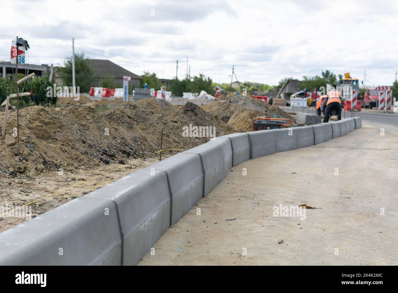 Cimislia region, Moldova - 20, September, 2022: Road junction construction on traffic road E584/M3. Workers moving road curb, installing blocks in the Stock Photo