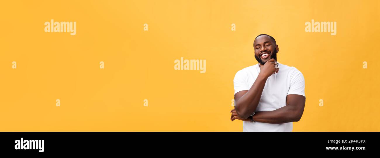 Portrait of a modern young black man smiling with arms crossed on ...