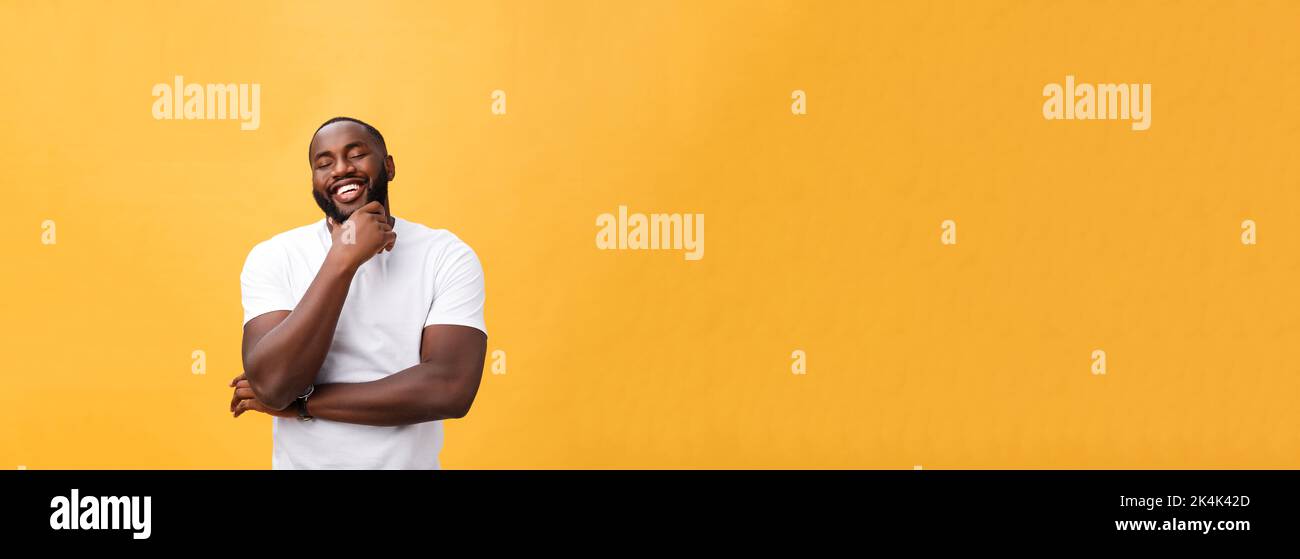 Portrait of a modern young black man smiling with arms crossed on ...