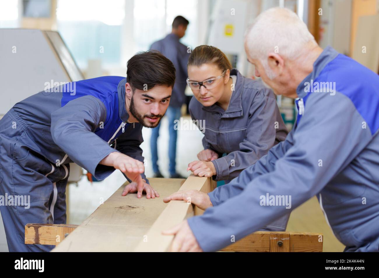 trainee carpenters discussing woodworking project Stock Photo
