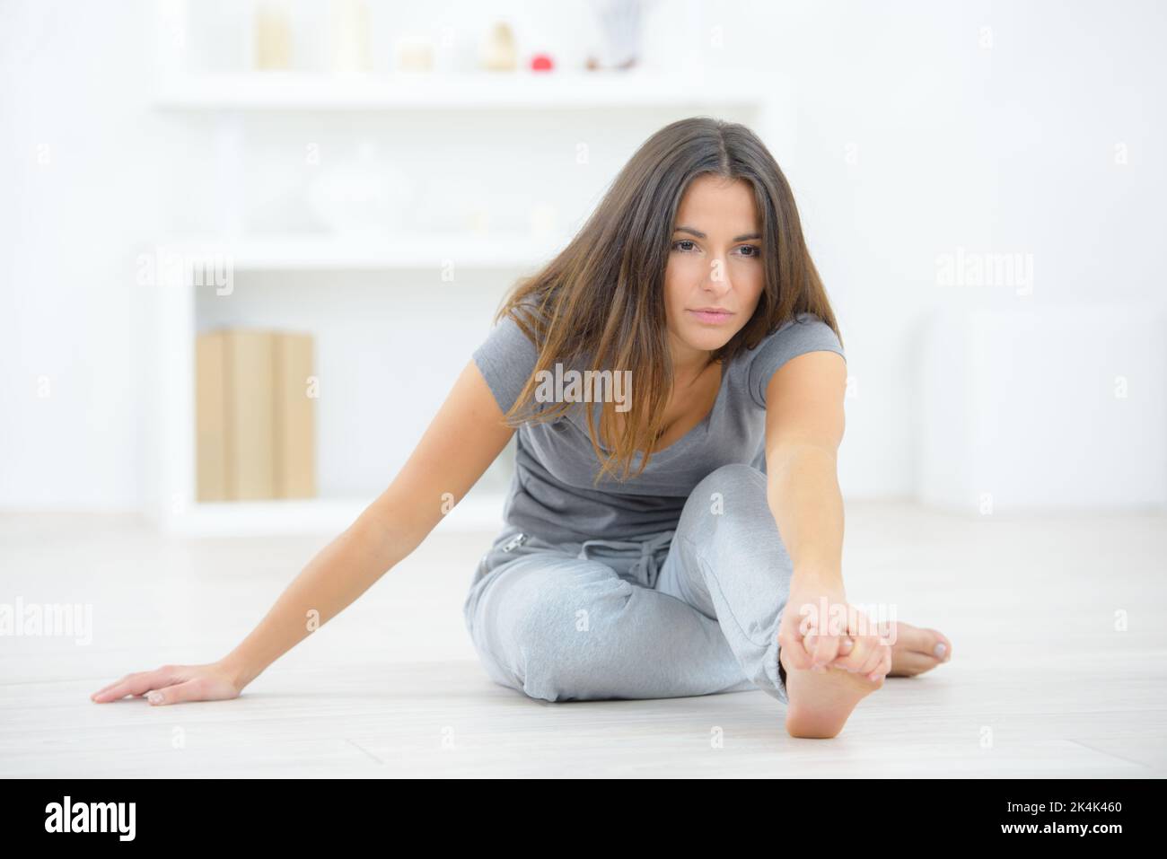 Woman on the floor stretching Stock Photo