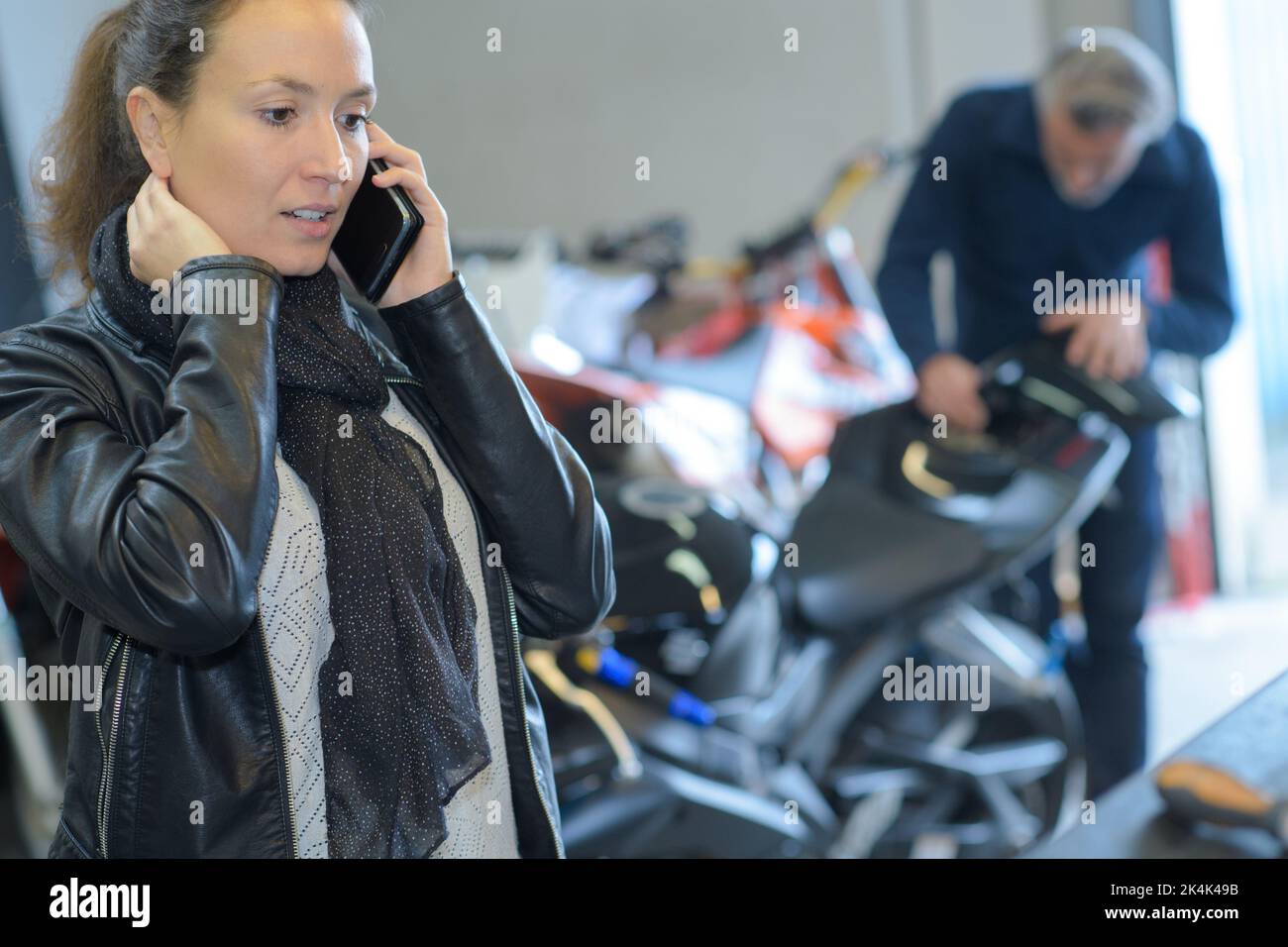 female customer on the phone buying new motorbike Stock Photo