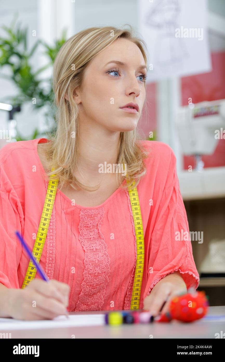Blonde fashion designer drawing clothes hi-res stock photography and ...