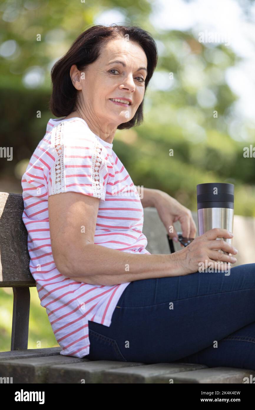 portrait of a mature woman sitting on a park bench Stock Photo - Alamy