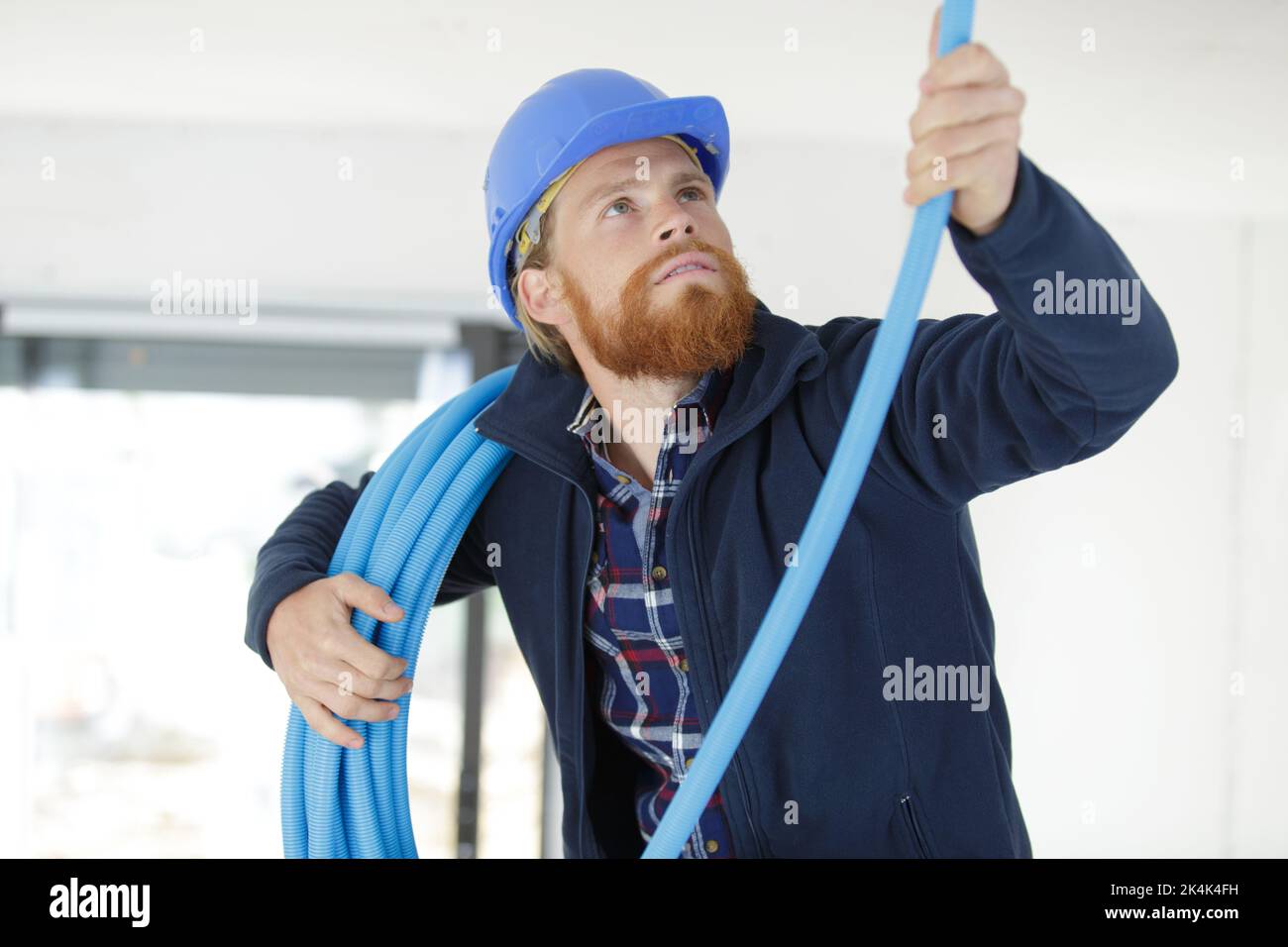 male contractor installing blue pvc pipe Stock Photo Alamy