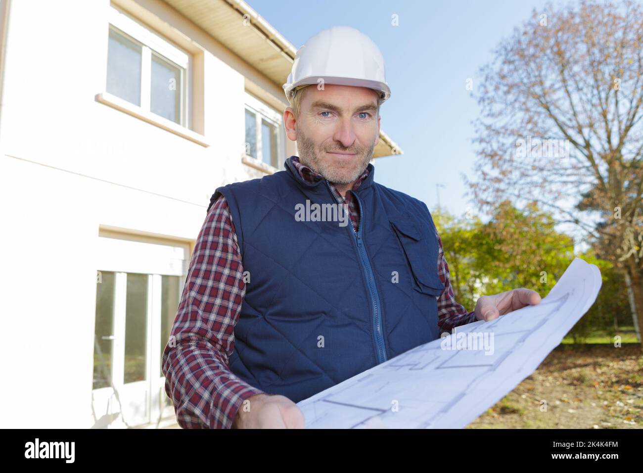 a foreman holding a blueprint Stock Photo