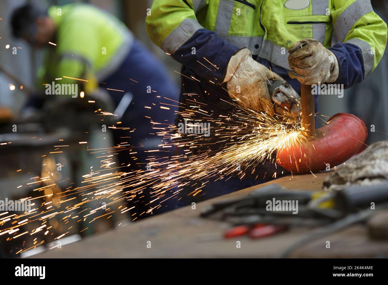 worker grinding cutting metal sheet with grinder machine Stock Photo