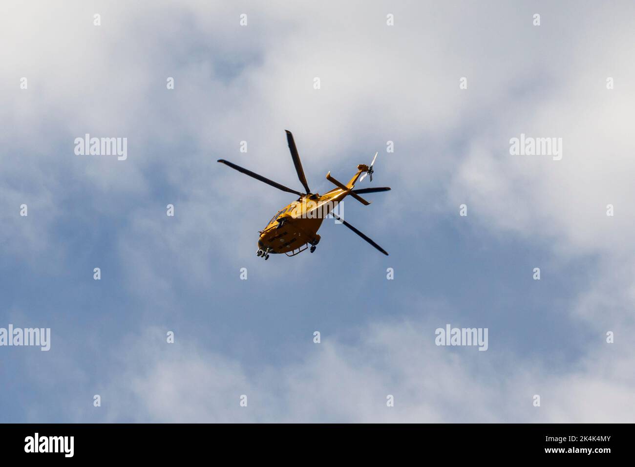 Air ambulance helicopter flying over Sussex, UK Stock Photo