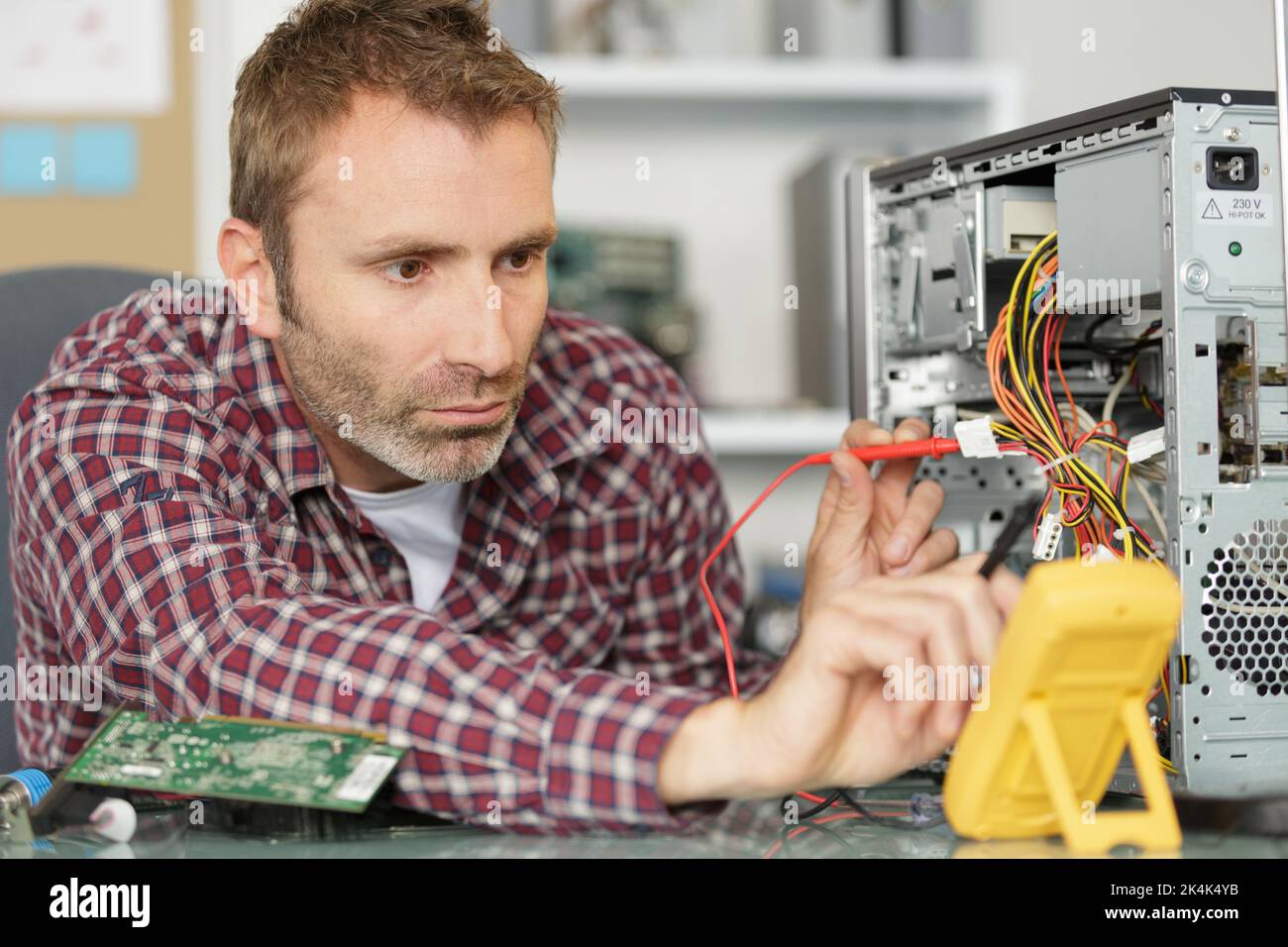 a male technician fixing computer Stock Photo