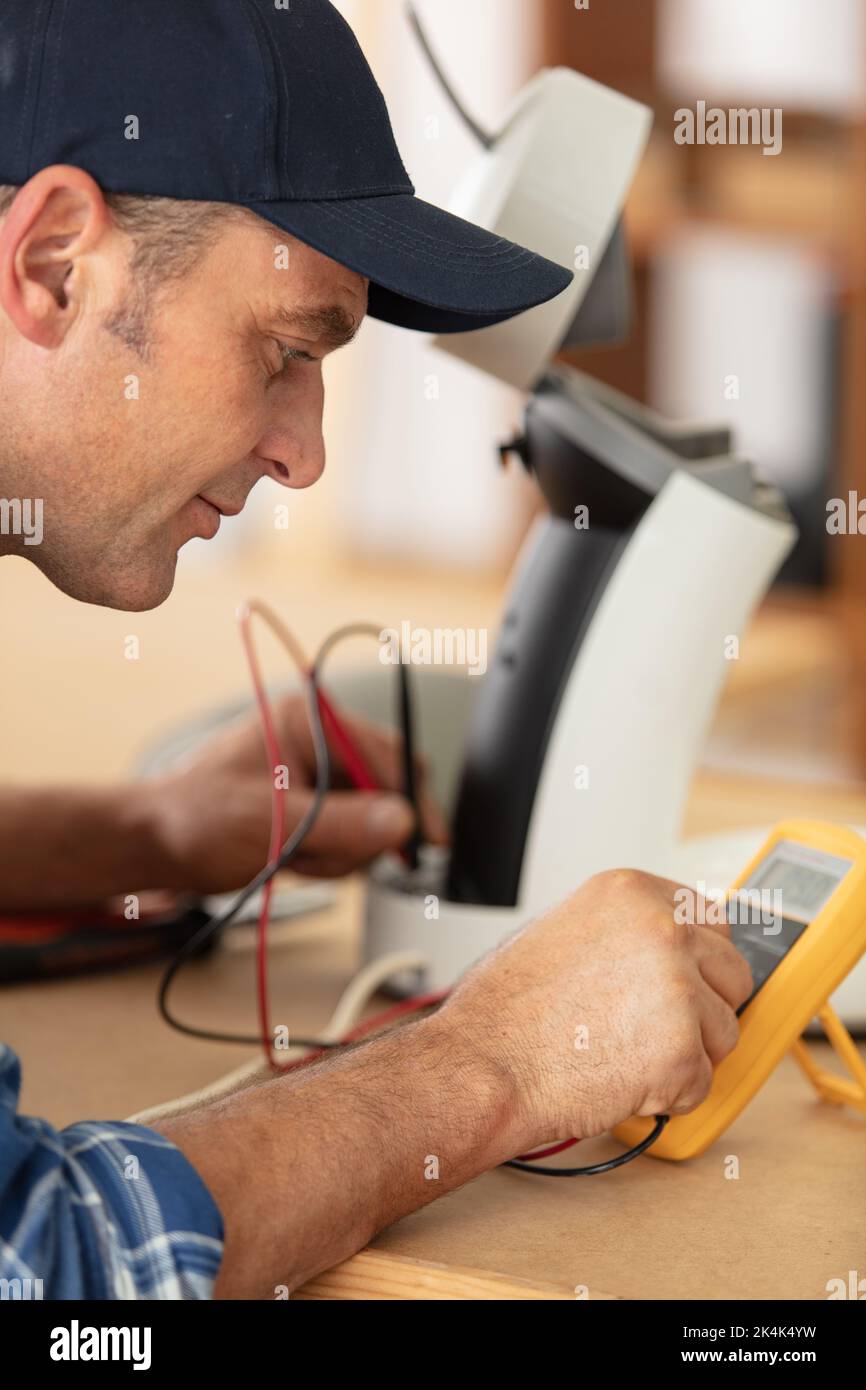 repairman testing an appliance with a multimeter Stock Photo Alamy