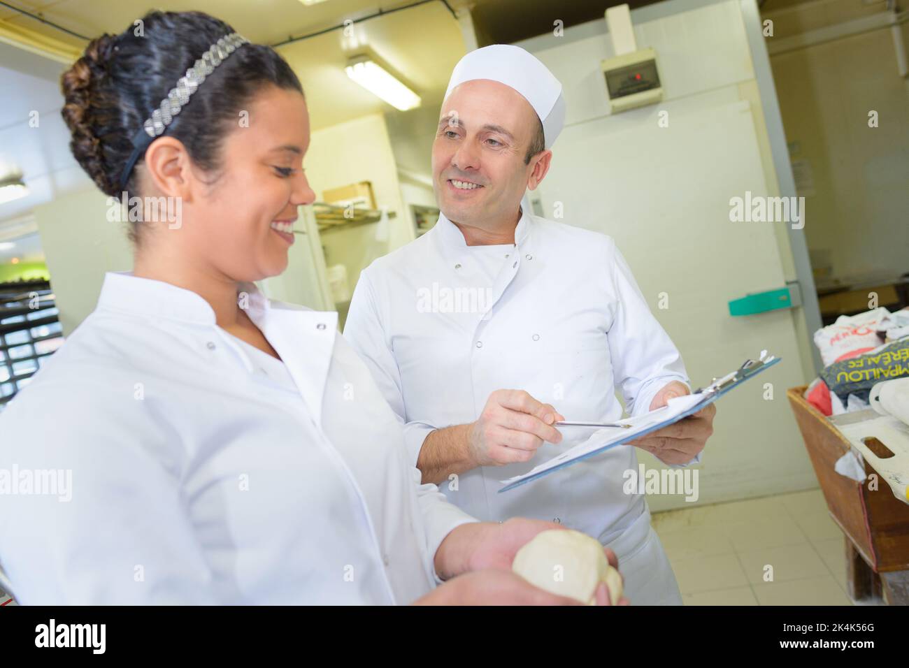 pastry cook professional team man and woman in restaurant kitchen Stock Photo