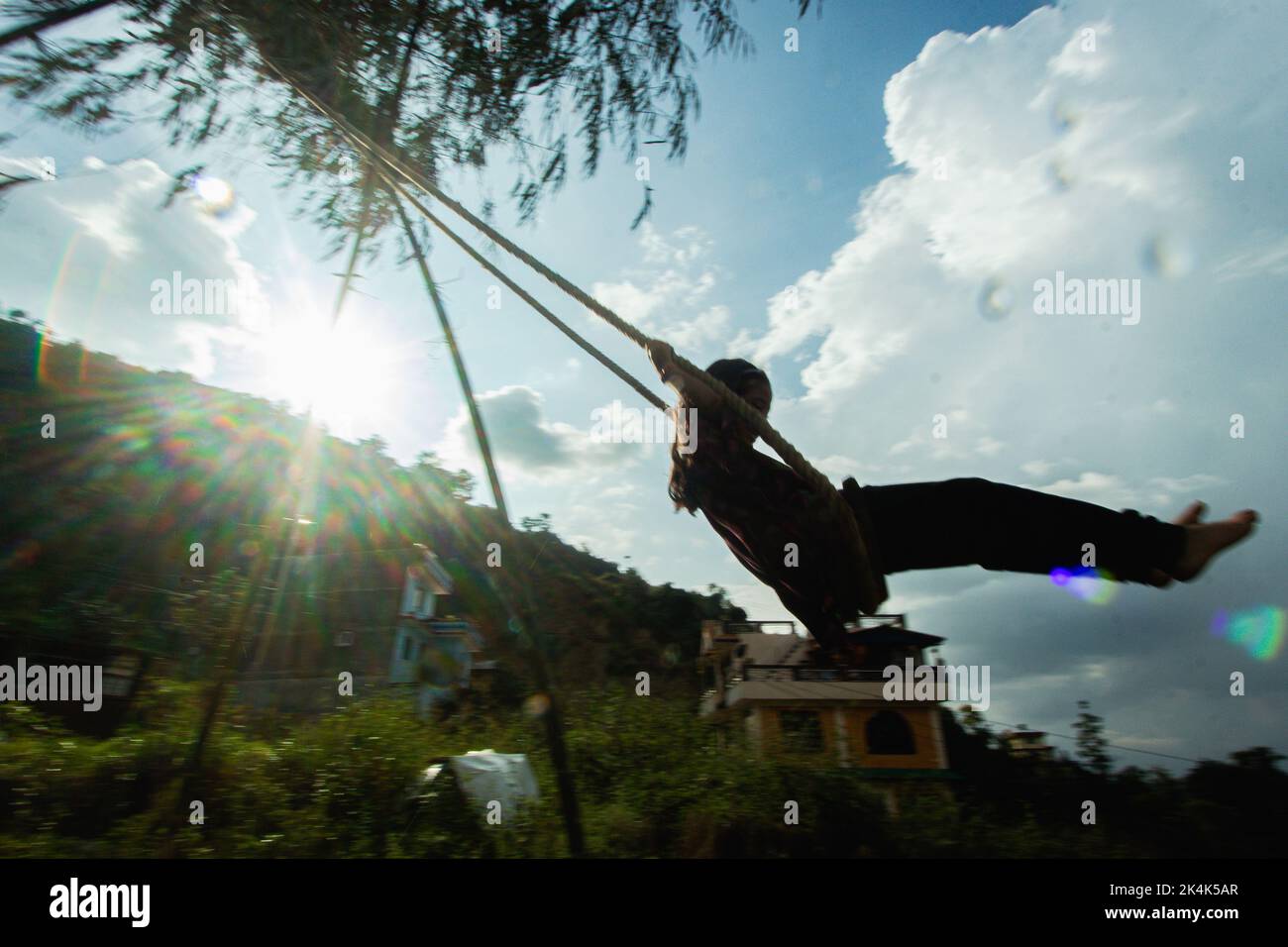 Nepal. 3rd Oct, 2022. Young boys and girls play traditional swing in