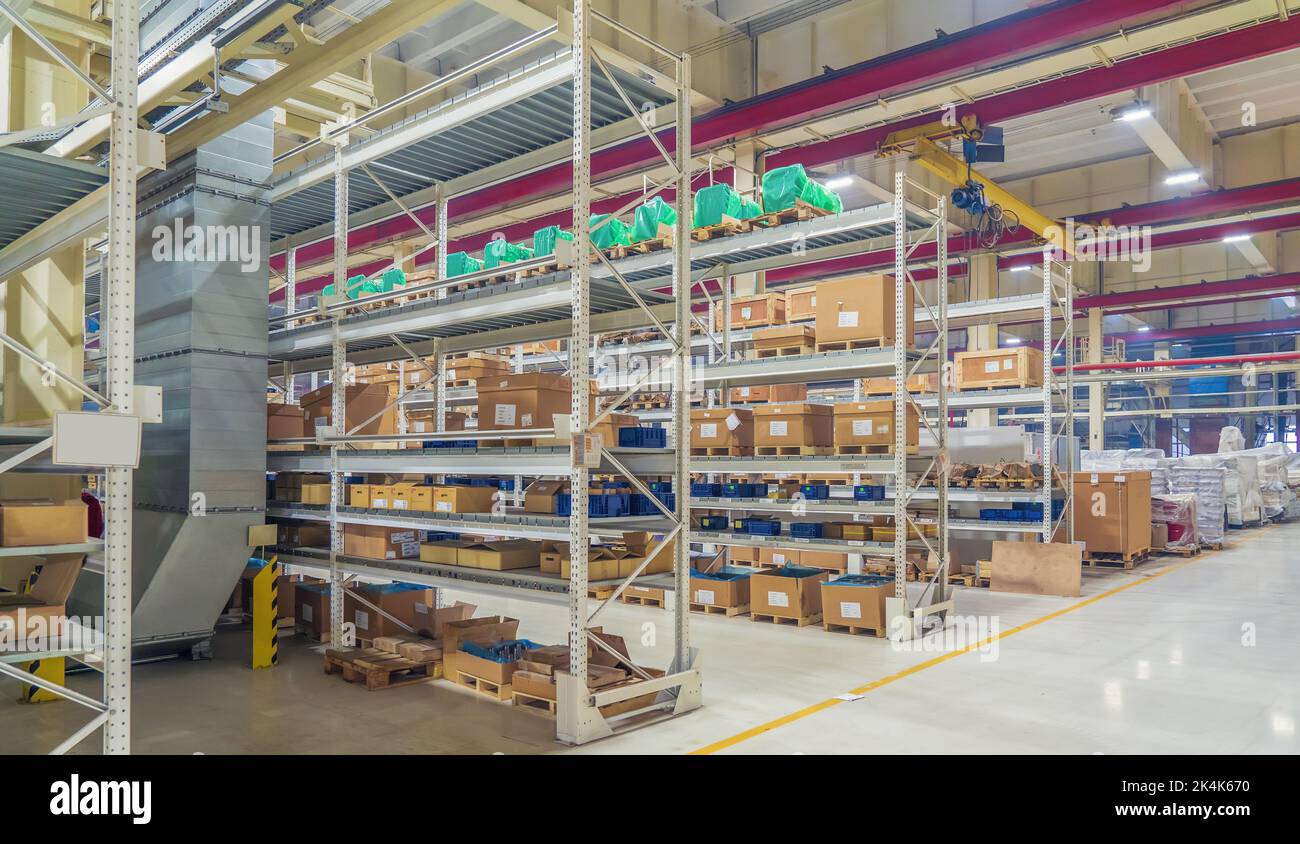 Shelves with goods boxes in distribution warehouse at industrial factory. Stock Photo