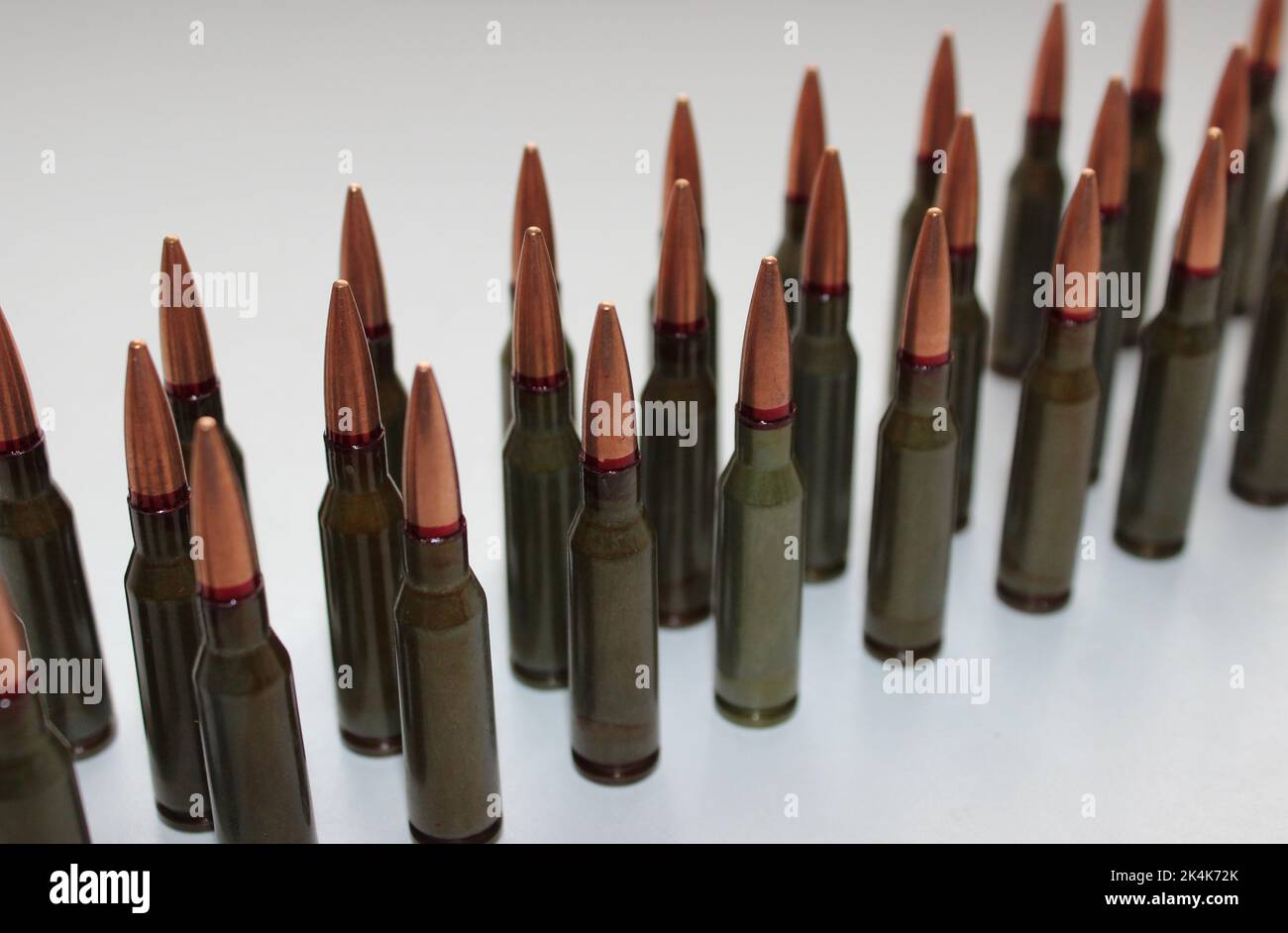 Unitary cartridges with copper alloy shell bullets lined up top view stock photo Stock Photo
