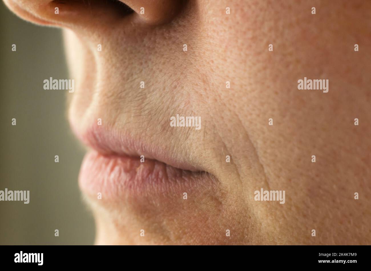Female mustache close-up. Mustache above the upper lip of a woman, close-up, selective focus Stock Photo
