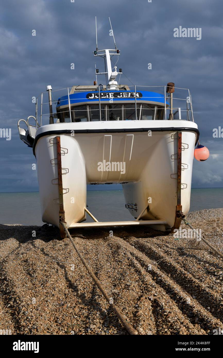 inshore fishing catamarran up on beach dungeness kent england Stock Photo