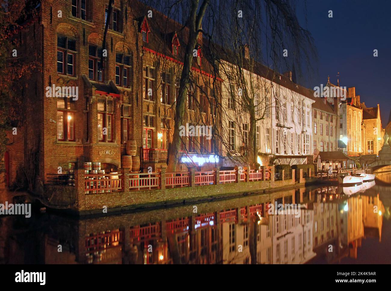 Brugge or Bruges, West Flanders, Belgium: The Dijver Canal in Brugge at night with the Bourgogne des Flandres Brewery and Distillery. Stock Photo