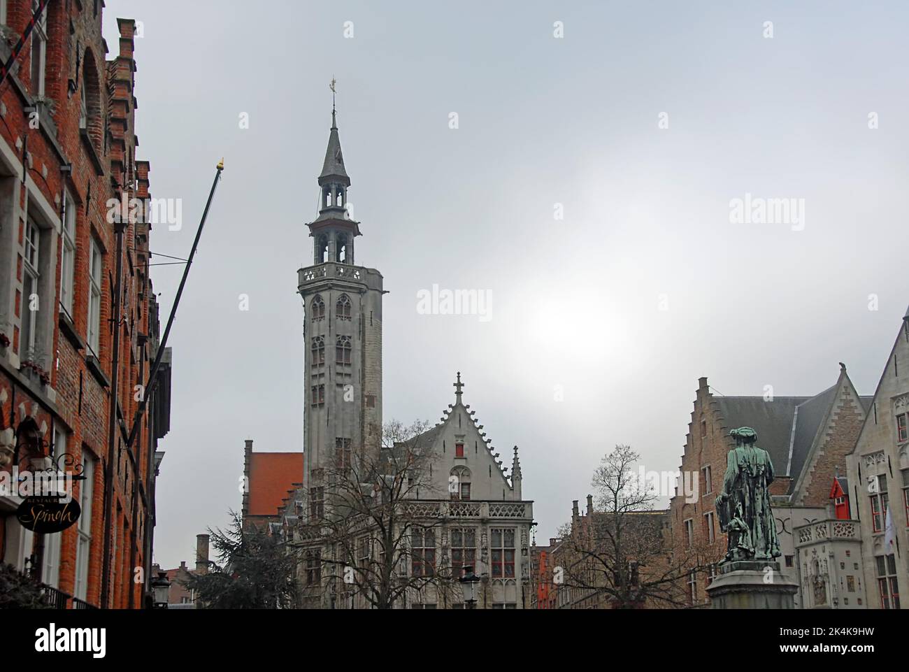 Brugge or Bruges, West Flanders, Belgium: Poortersloge or Burghers' Lodge in Brugge. View with the Jan Van Eyck statue in the foreground. Stock Photo
