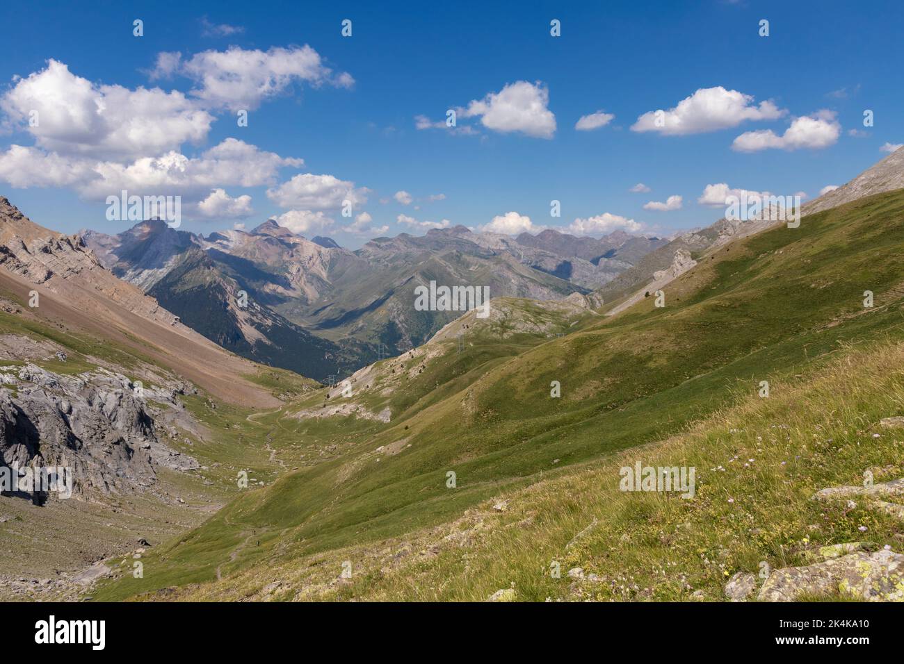 Picturesque view of the Pyrenees landscape with green meadows and mountains during the day. Summer trip in the mountains Stock Photo