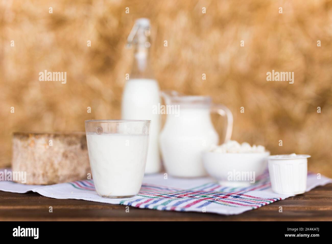 jug of milk, bottle of kefir, cottage cheese, cream and yogurt in bowl, cheese, butter in mow Stock Photo