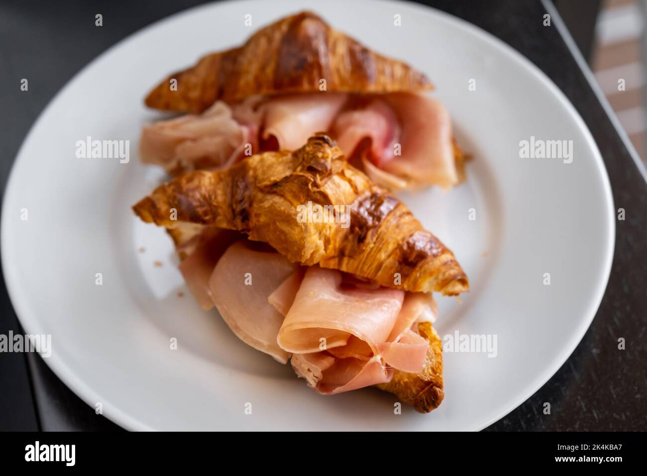 Croissants sandwiches with prosciutto (jamon, cured ham, prosciutto