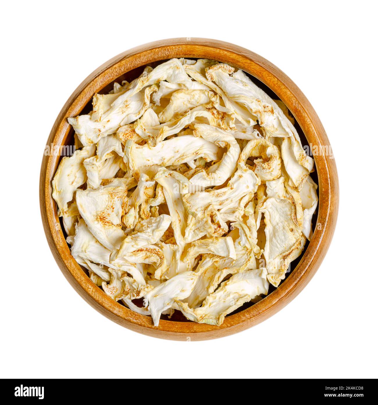 Celery root, dehydrated slices, in a wooden bowl. Celeriac, knob or turnip rooted celery, Apium graveolens var. rapaceum, a root vegetable. Stock Photo