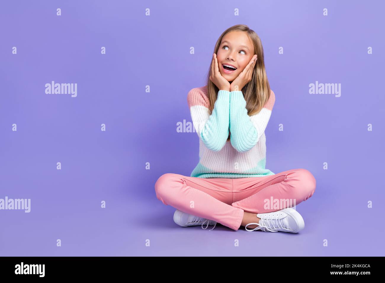 Full length photo of astonished girl sit arm touch face look empty ...
