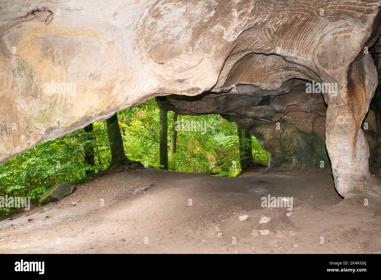 Huel Lee or Hohllay on the Mullerthal trail in Luxembourg, open cave with view to the forest, sandstone rock formation Stock Photo
