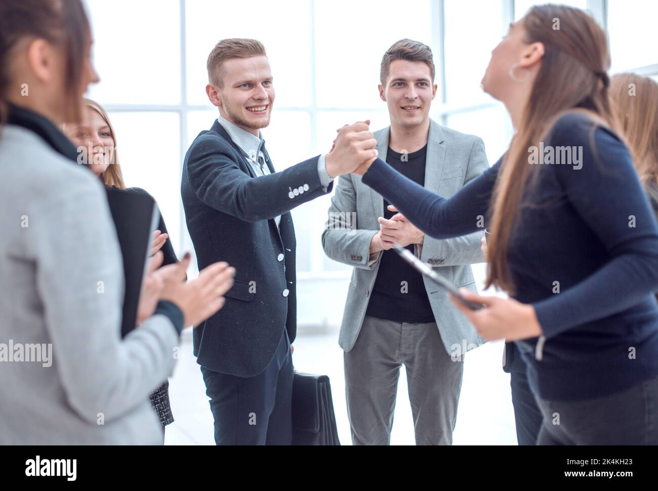 young employees giving each other a high five Stock Photo - Alamy