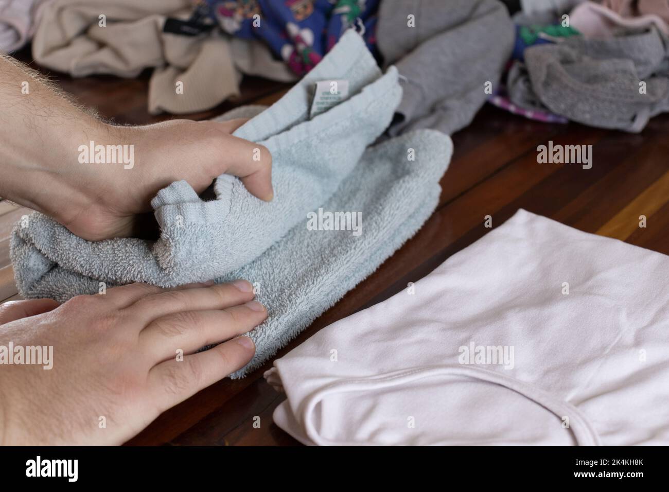 Married man arranging freshly washed clothes Stock Photo