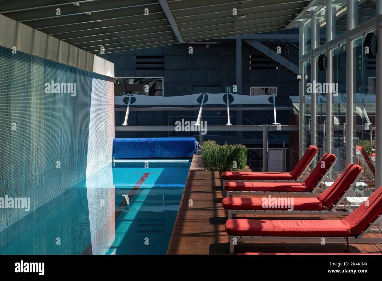 complex of luxury buildings, with pool amenity, lounge chairs, planters