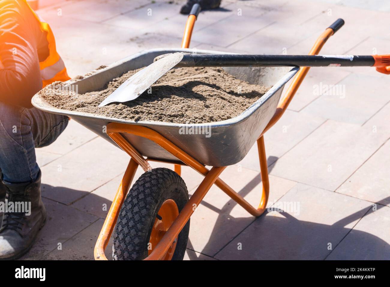 construction wheelbarrow with sand and shovel Stock Photo Alamy