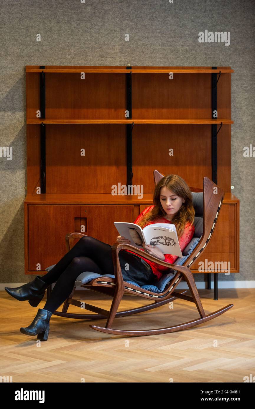 London, UK. 3 October 2022. A staff member sits on 'Rocking chair ...