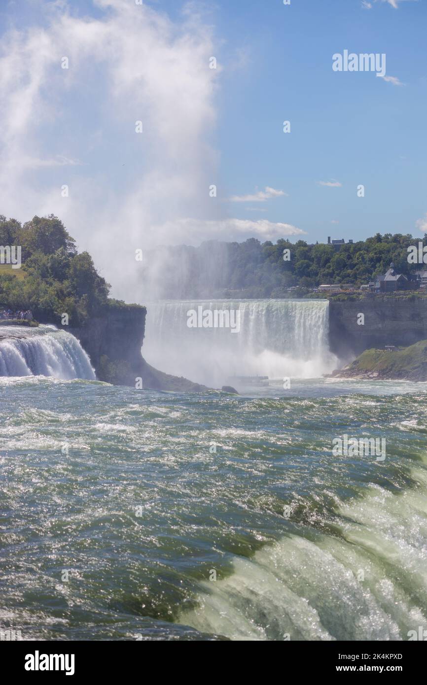 A raging waterfalls surrounded by trees Stock Photo - Alamy
