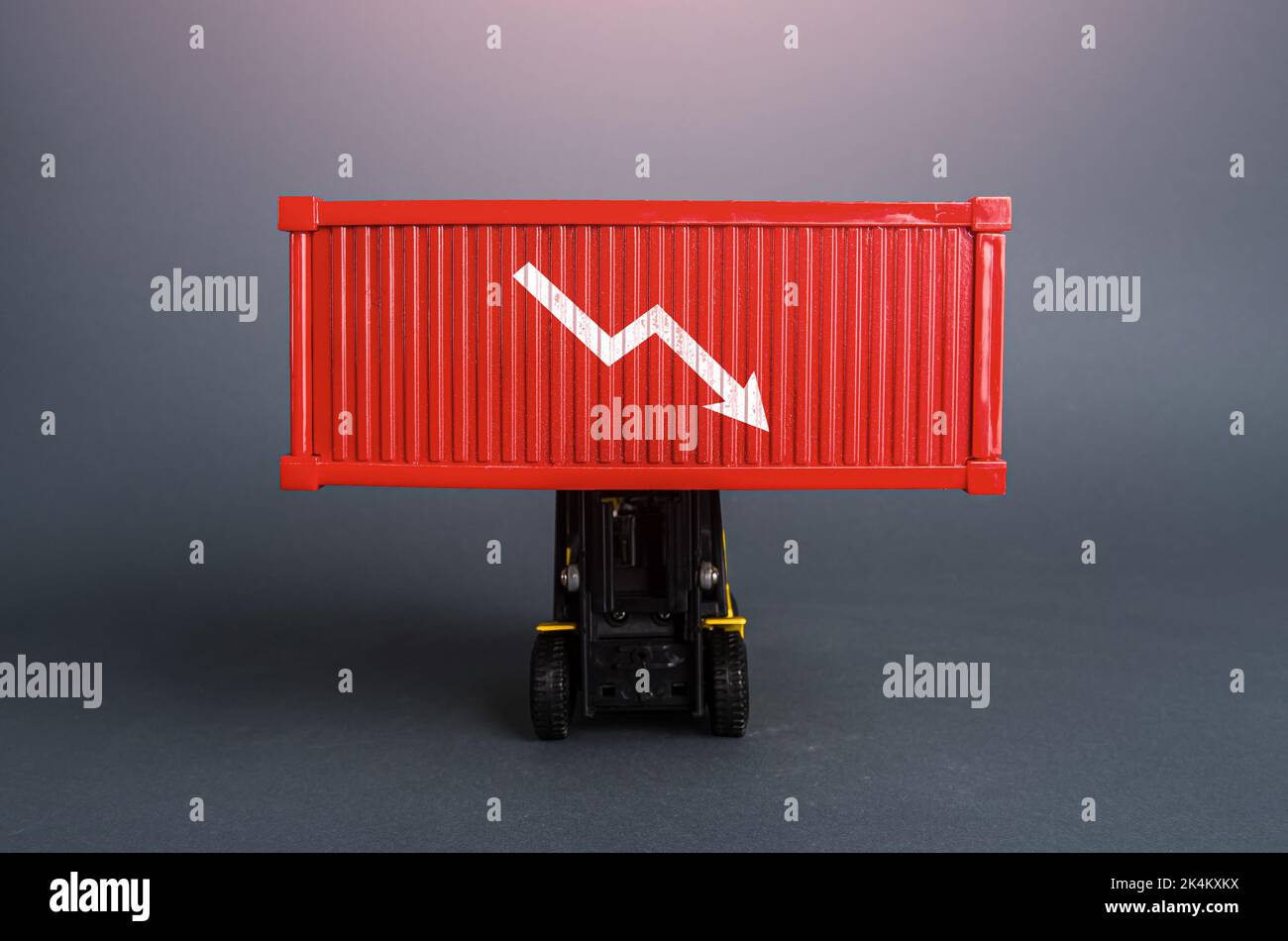 Red shipping container with down arrow. Decrease in imports and exports of goods. Trade traffic decreasing. Production fall. Lowering transportation p Stock Photo