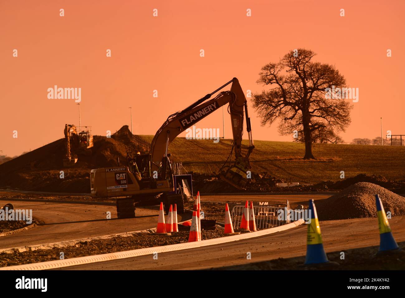 heavy earth moving machinery building Leeds Orbital road at sunset
