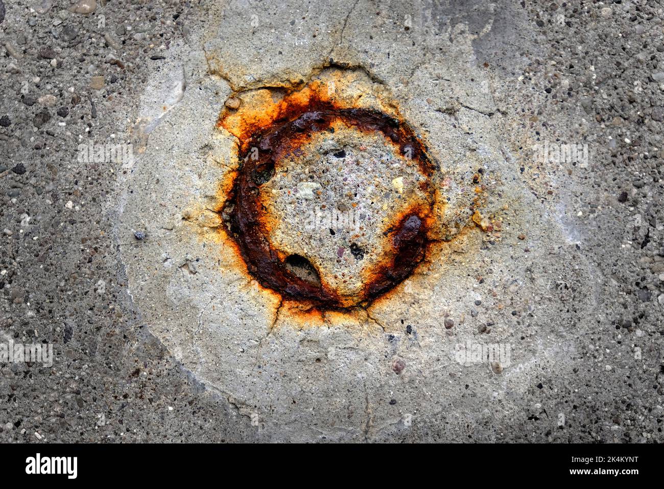 Orange rusted round spot on concrete texture from cut pole removed Stock Photo