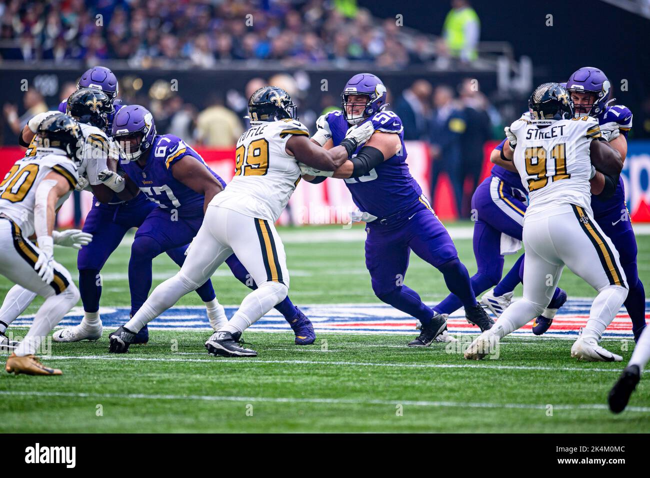 LONDON, UNITED KINGDOM. 02th, Oct 2022. Adam Thielen of Minnesota Vikings  (left) is tackled by Paulson Adebo of New Orleans Saints (right) during NFL  2022 London Series - Minnesota Vikings vs New