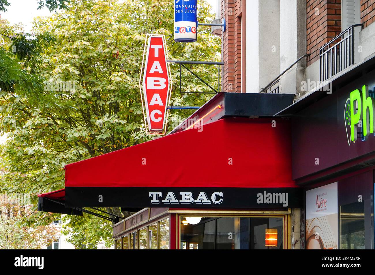 Café-tabac, bar, cafe, also selling cigarettes, lottery tickets and sometimes stamps, notable by the red diamond-shaped sign outside, Paris, France. Stock Photo